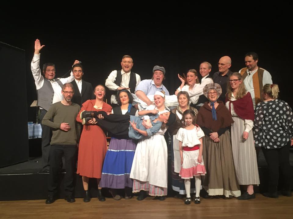 Teatertruppen fra SkarnTyden samlet på scenen efter forestilling, smilende og klædt i kostumer